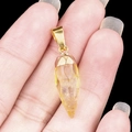 Hand-held yellow crystal point pendant with natural ice texture and gold metal bail - Citrine
