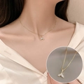 Golden fish tail pendant necklace with crystals on box chain shown on model - 23# Necklace-Gold Fishtail