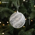 Sparkling silver glitter Christmas ball with white wavy ribbon hung on a green tree branch - Silver Glitter Ball Style B