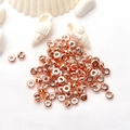 Rose gold flat round spacer beads for DIY jewelry making on white textured background - 8mm / Rose Gold / Color Retention