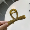Detail of amber translucent bow hair claw clip with golden metal spring mechanism - Medium 8cm / Jelly Yellow Green