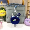 Detailed view of colorful plush monster keychains on a denim bag with fuzzy texture - Sapphire Blue