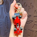 Red F1 racing car keychain with golden metal ring and lobster clasp for bags - Red