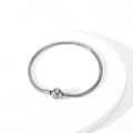 Close-up of silver snake bone bracelet with a round clasp on a minimalist display stand - Steel Color Ball Clasp