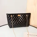 Elegant black quilted tote bag with glossy finish and golden chain shoulder strap - Black