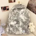 Detail of grey tie-dye canvas backpack featuring cute cartoon patches and plush bear charms - With 4A Badge and Blush Bear / Black