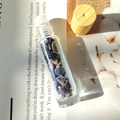 Essential oil glass roller bottle with blue natural crystals and a wooden cap - Sodalite