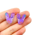 Detail of purple acrylic letter V pendant with colorful smiley and flower patterns - Letter V