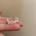 Adjustable silver ring with hollow flower design worn on finger for a stylish minimalist look - J926 Hollow Flower Style (J926)