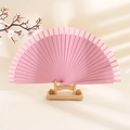 Minimalist matte pink wooden folding fan displayed on a natural wood stand - Light Pink