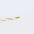 Minimalist gold necklace featuring a polished oval bean pendant on a delicate link chain - Letter I