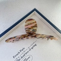 Close-up of a 13.5cm large tortoiseshell hair claw clip with colorful resin textures - Brown Pink