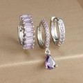 Macro detail of silver geometric earrings set featuring purple zircons and teardrop pendant - Three-Piece Set / Silver - Purple Zirconia