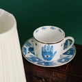 Set tazza e piattino in ceramica nordica con motivo occhio di Hamsa blu e oro - Mano di Fatima Tazza e Piattino