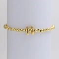18K gold-plated beaded stretch bracelet featuring a bubble style letter M pendant charm - Gold M