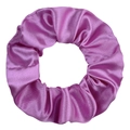 Detailed view of magenta satin scrunchie with glossy texture and elegant folds - Violet