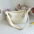 Cream canvas half-moon crossbody bag with cute puppy pendant and wide strap - Beige
