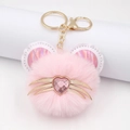 Pink plush cat paw keychain with golden whiskers and a heart-shaped rhinestone nose - Round Ears