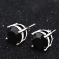 Detailed macro view of black zircon earrings with silver four-claw setting and striped base - 4mm / White Gold - Black Zirconia