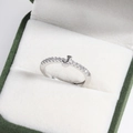 Macro shot of silver J-letter ring with diamonds in a green velvet gift box - Platinum J