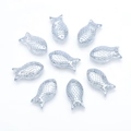 Macro detail of transparent light blue fish-shaped glass charms with scale texture - Light Blue Grey