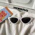 Macro shot of stylish white cat-eye sunglasses with dark lenses on soft white fabric - Cat Eye / White Frame Grey Lens