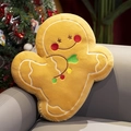 Gingerbread man plush pillow in warm yellow on a leather sofa with Christmas tree - Dancing Gingerbread Man
