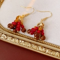 Detailed close-up of Bohemian earrings with red and brown wooden beads in a vintage gold frame - Ear Hook-Gold-Red