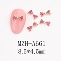 Macro view of 8.5x4.5mm gold metal bow nail charms with pink rhinestones - Full Pavé Bow (A661)