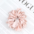 Pink satin scrunchie with silky pleated texture on a fashion magazine background - Ivory