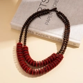 Detail of bohemian double-layer necklace with brown wood beads and red coconut discs - Red