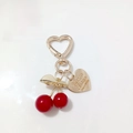 Golden cherry leaf charm with red resin beads and a heart-shaped carabiner clasp - Red Cherry Brand Engraved Heart Buckle (Cherry P)