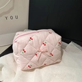 Pink quilted cotton makeup bag featuring cute red cherry patterns and a bow detail - Pink Cherry Style