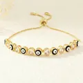 Detail of adjustable golden Evil Eye bracelet with enamel beads and clear cubic zirconia - Black and White (Style H)