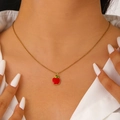 Close-up of a sweet red apple enamel pendant necklace on a gold-plated chain - Apple Style (DZ-523)