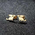 Symmetric pair of golden stainless steel dragon stud earrings on a textured grey background - Flying Dragon / Gold