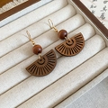 Detailaufnahme fächerförmiger Holzohrringe mit Goldhaken in einer Schmuckbox - Fächerförmiger hohler Holzperlen-Stil / Ohrhaken-Kaffee