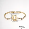 Detailed view of gold tennis bracelet with zircon letter G charm and size measurements - Letter G