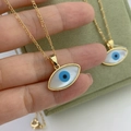Golden Figaro chain necklace with oval mother of pearl evil eye pendant in a gift box - Gold