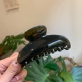 Detail of a large translucent dark green hair claw clip with a glossy acetate finish - 10cm Yuanbao Claw / Translucent Grey Green