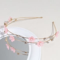 Detail of pink flower hairband with pearls and rhinestones on a gold metal base - Pink