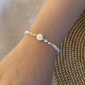 Detailed shot of beaded letter I bracelet with pearls and golden accents on model - Letter I Style (I)