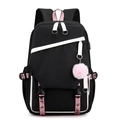 Minimalist black student backpack with pink accents and plush pendant on white background - Black and White