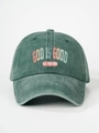 Detailed close-up of retro washed green baseball cap with God Is Good printed text - Dark Green