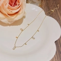 Elegant gold titanium necklace featuring five rectangular zircon pendants on a white plate - X504 Gold Row Diamonds Rectangular