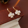 Macro shot of gold-plated clover earrings with pearl inlay and sparkling zircon detail - Ear Hook - Gold (Real Gold Plating)