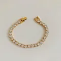 Golden tennis bracelet featuring round-cut crystals and a secure folding clasp - Gold Zirconia Tennis Chain (SBK444)