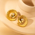 Detail of golden spiral flower earring with central crystal and radial texture - Rhinestone Conch Stud Earrings