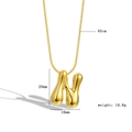 Macro shot of 18k gold plated bubble letter N pendant with size and weight dimensions - Letter N