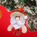 Dettaglio di un addobbo a forma di Babbo Natale con campanella rossa su un albero innevato - Babbo Natale con campanello tondo rosso
